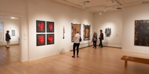 People in an art gallery looking at work on the wall
